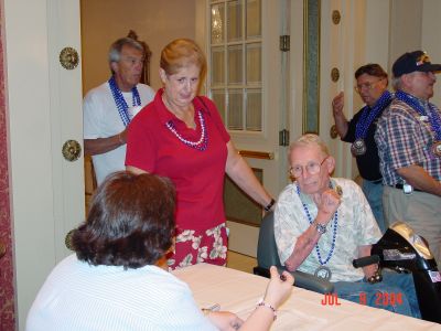 Lil and Tom Rupert arriving from Virginia Beach, VA registering with 
Karen Layus.
