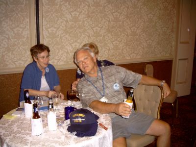 Lin Greidanus chatting with Carol Merrick...Bruce Merrick leaning in front 
of his wife.
