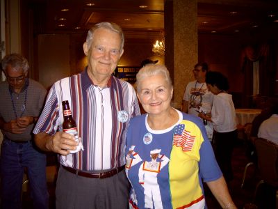 Tom and Barbara Boyce sipping and smiling for the camara at the reception.
